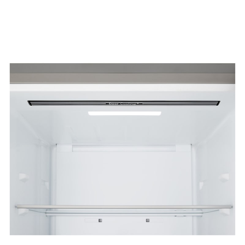LG fridge freezer (GBBS323CPY) built into dark brown cabinetry with window and sofa on left and sink on right
