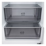 LG fridge freezer (GBBSJ10DEP) built into dark brown cabinetry with window and sofa on left and sink on right