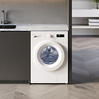 Lave-linge LG F94B13WH blanc installé sous un plan de travail en marbre dans une buanderie moderne avec un sol en chevrons.