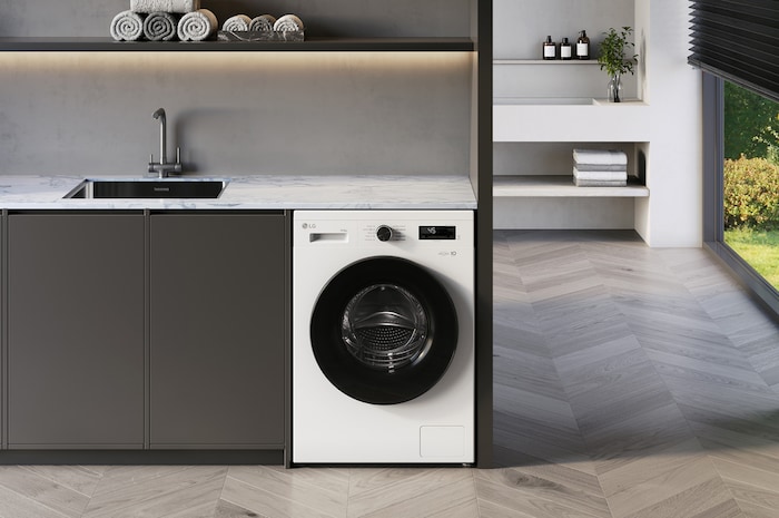 Lave-linge séchant LG F854B16WHS blanc installé sous un plan de travail moderne, doté d'un hublot noir élégant contrastant.