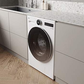 Lave-linge LG F14X71WSTA blanc installé sous un plan de travail en terrazzo dans une buanderie moderne et lumineuse.