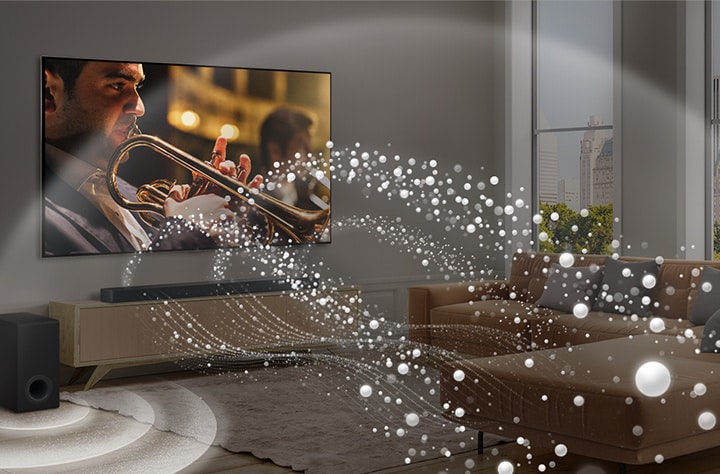 Une LG Soundbar, une LG TV et un caisson de basse sont placés dans un appartement urbain moderne. La LG Soundbar émet des ondes sonores composées de gouttelettes blanches emplissant la pièce et un caisson de basse crée un effet sonore à partir du bas. Ensemble, ils créent un effet de dôme dans la pièce.