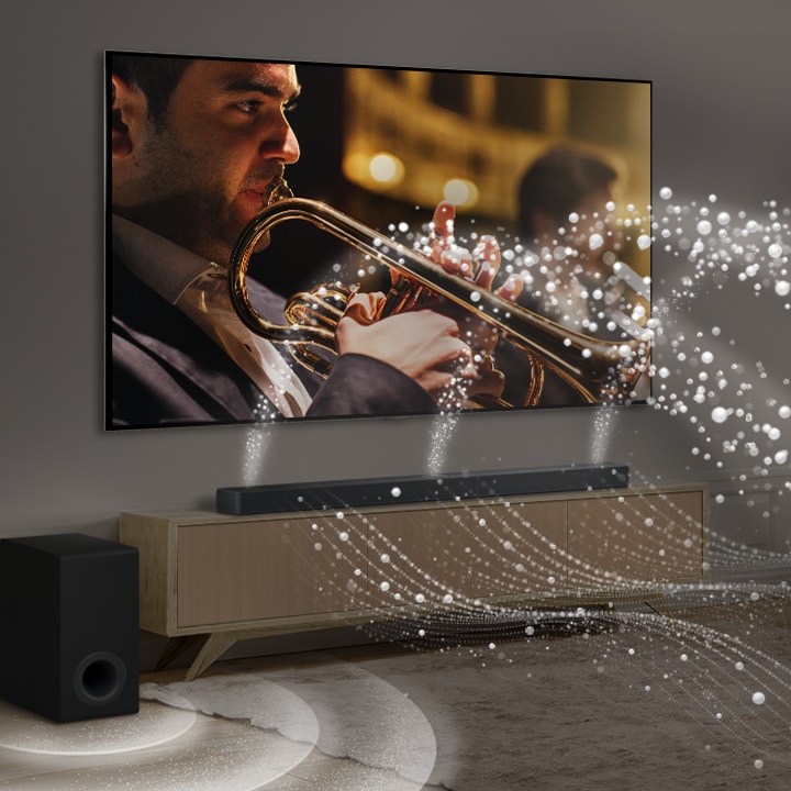 Une LG Soundbar, une LG TV et un caisson de basse sont placés dans un appartement urbain moderne. La LG Soundbar émet des ondes sonores composées de gouttelettes blanches emplissant la pièce et un caisson de basse crée un effet sonore à partir du bas. Ensemble, ils créent un effet de dôme dans la pièce.