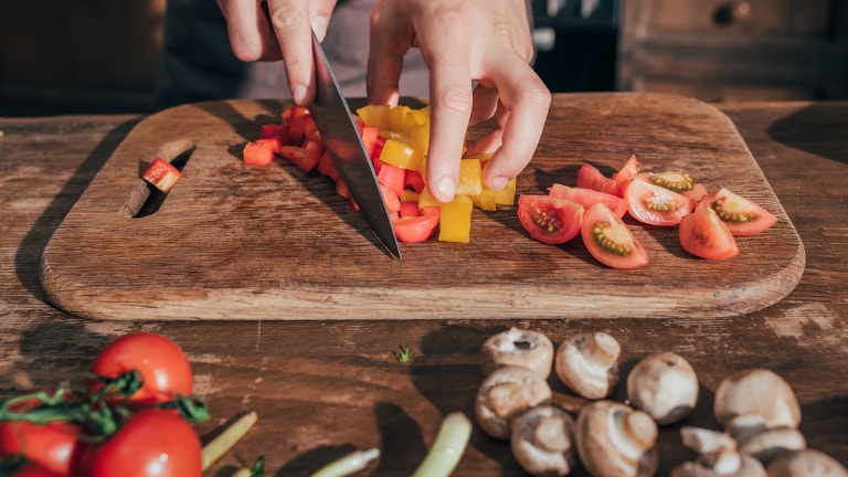 Image d’une découpe de tomates et d’une planche à découper avec un couteau.