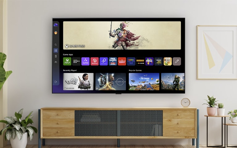 Two people sitting in a cozy living room, watching an LG smart TV displaying a user interface with streaming apps, surrounded by plants and modern decor