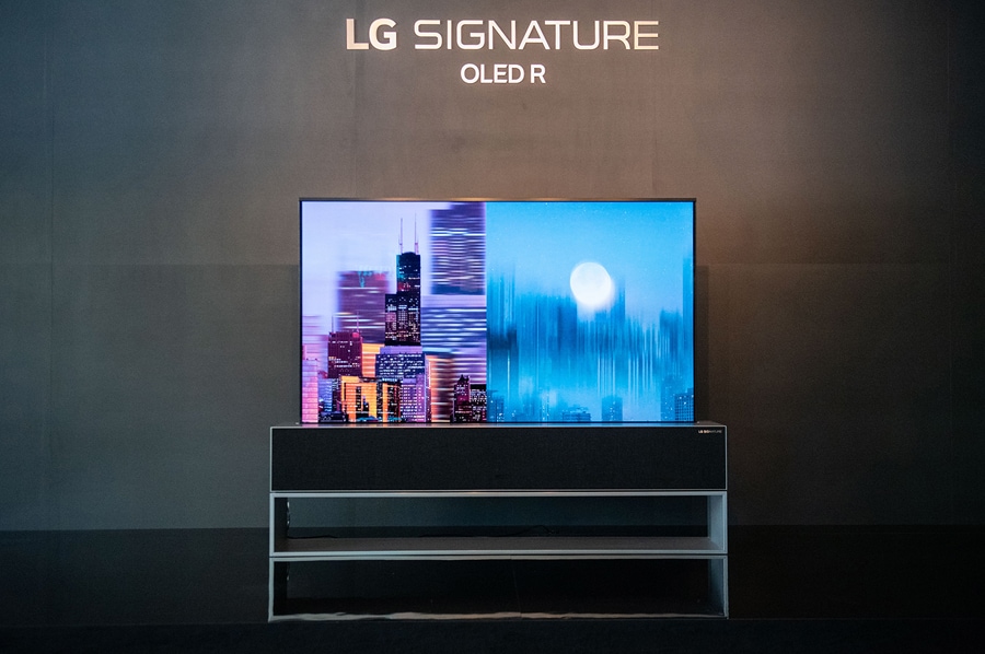 LG SIGNATURE Rollable OLED R rollable TV with nighttime cityscape images displayed