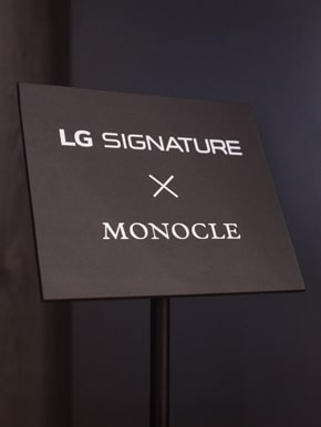 Floor standing sign in the LG SIGNATURE exhibition hall marked LG SIGNATURE X MONOCLE.