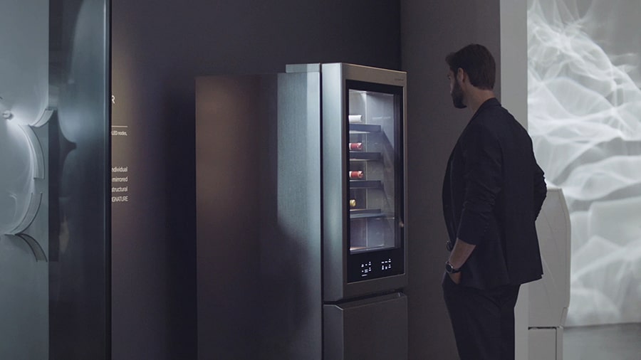 a man is looking at lg signature refrigerator at ifa 2018