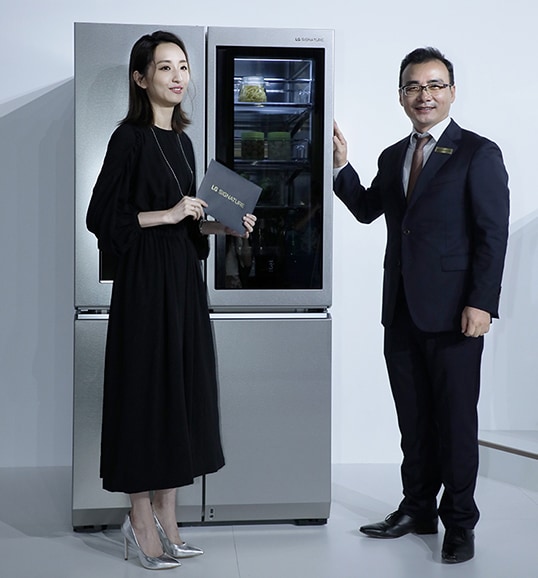 people are standing in front of lg signatrure refrigerator at lanching event in taiwan