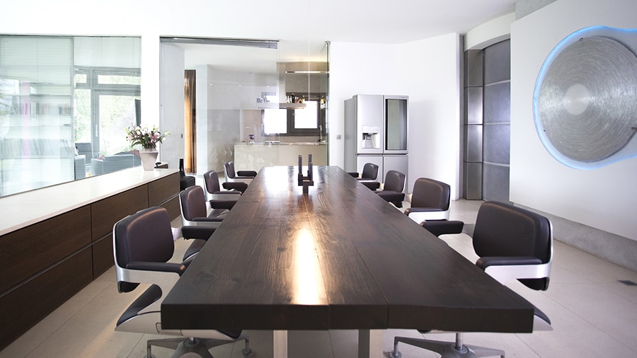 overall view of conference room with a huge wooden table and many chairs