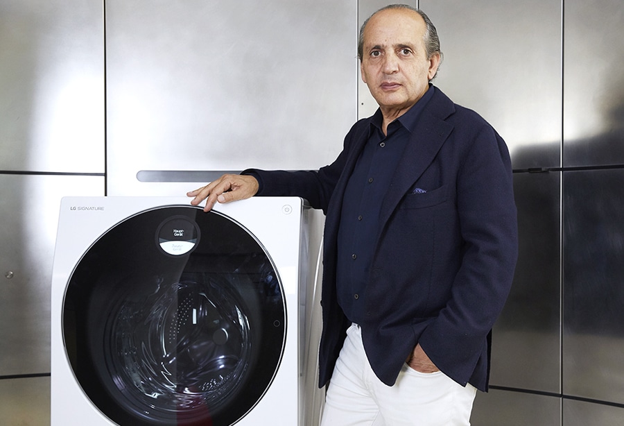 hadi teherani is standing right next to the lg signature washing machine