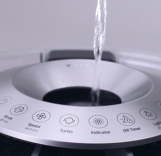 close shot of water being poured in to lg signature air purifier