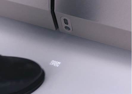 close shot of a foot which is tagging itself under the auto open door sensor of lg signature refrigerator