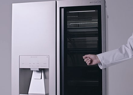 close shot of a hand knocking on the instaview of lg signature refrigerator