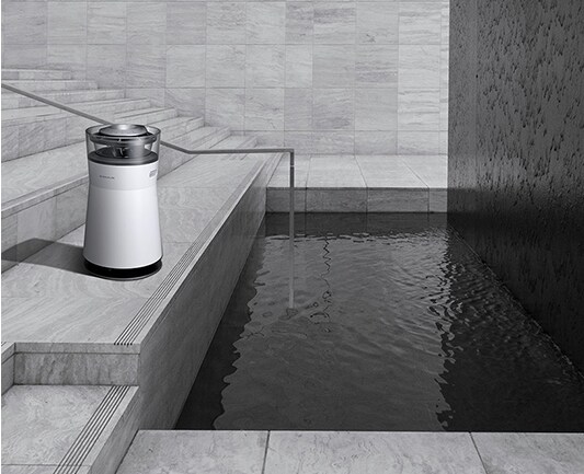 a black and white image of lg signature air purifier which is laid on the stair case located on the left side of the architectural spot