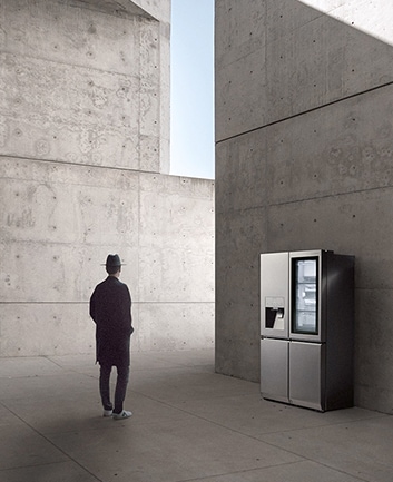 creator and photographer of minh tran is standing in front of lg signature refrigerator and staring it in the overall unique architectural site