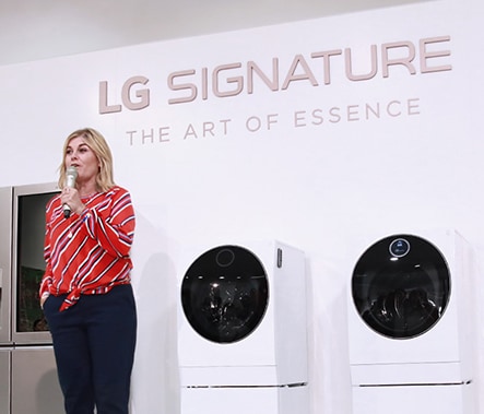 a woman influencer is talking on the main stage in front of all the lg signature products displayed in a row at launching event in nordics