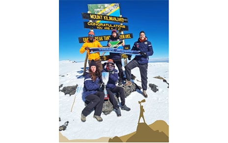 Members of FC Cambounet pose for a group photo at the peak of Mount Kilimanjaro.