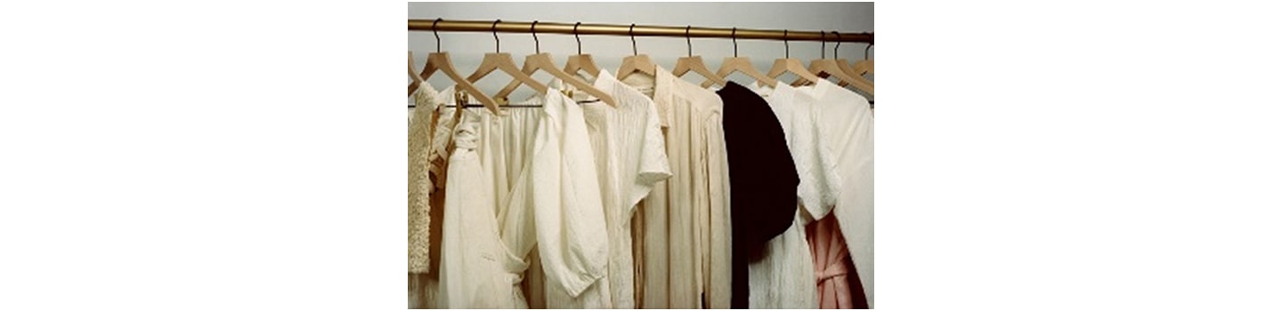 Elegant and sustainable women's clothing hanging on a rack.