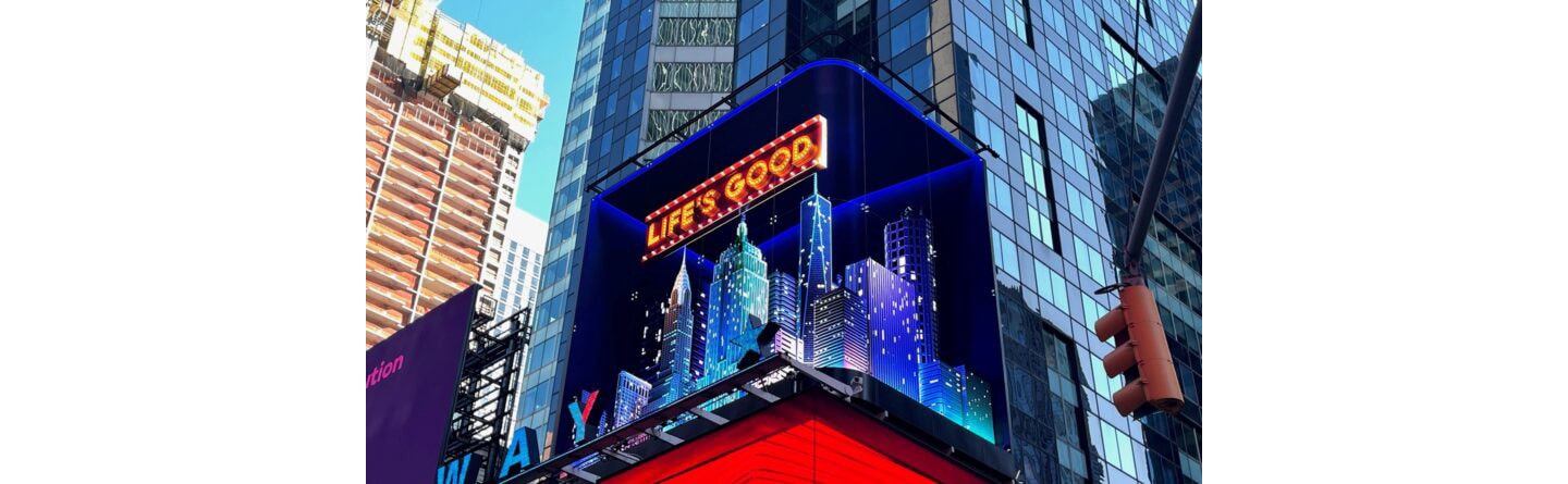 LG's digital billboard in Time Square, New York displaying an illustration of NYC with the phrase 'Life's Good'