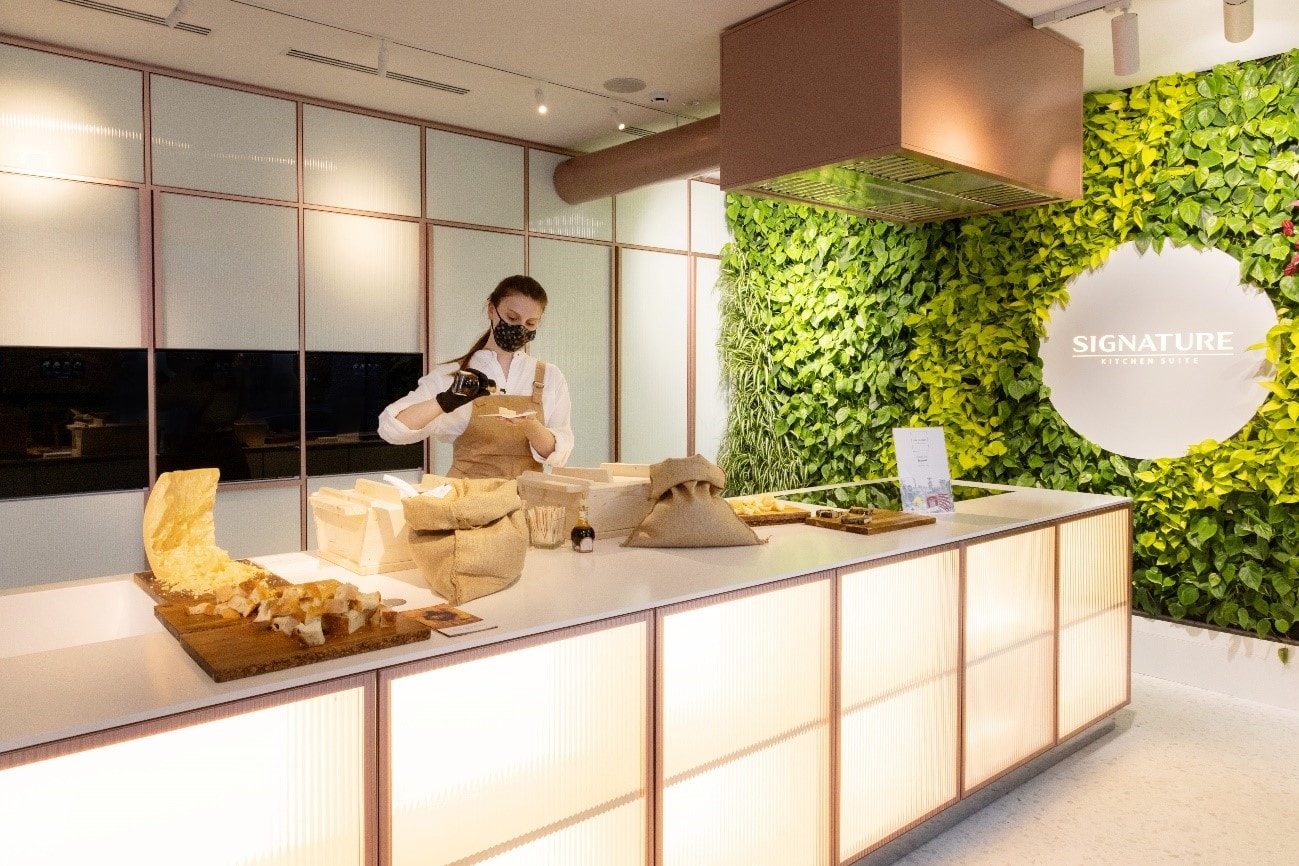 Staff preparing small dish at Signature Kitchen Suite showroom 