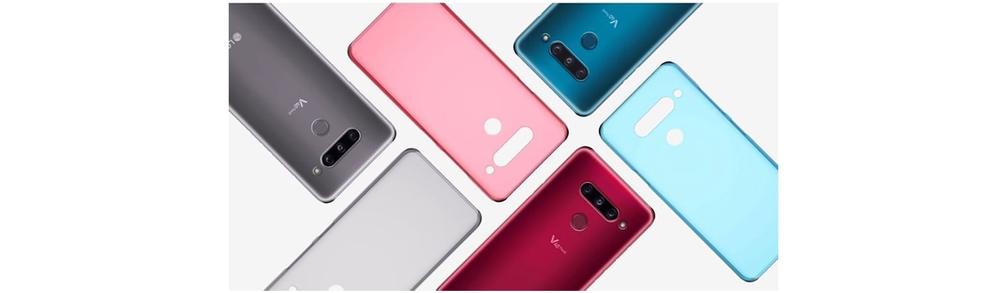 Three LG V40 ThinQs face down on a table with back cases positioned in a brick pattern.