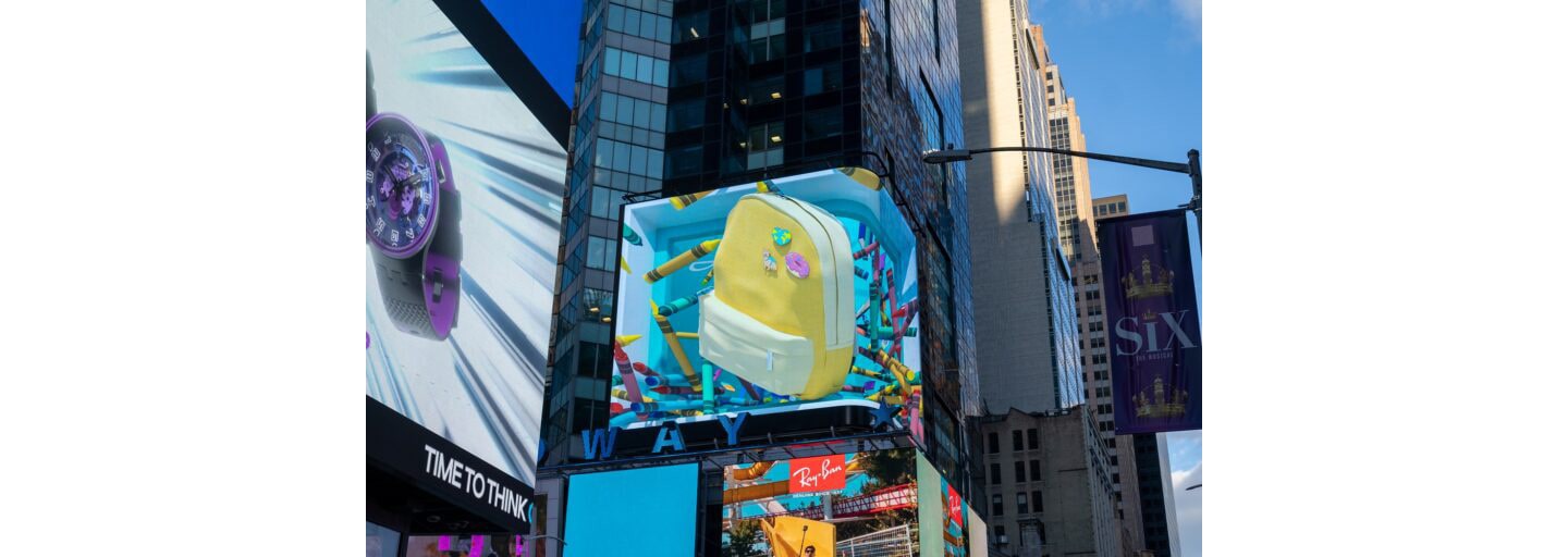 The Life’s Good Campaign video displaying a child’s backpack surrounded by crayons on the massive LG display in Times Square, New York City.