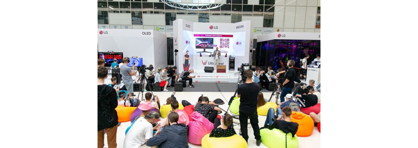 A large audience watches on as an LG representative makes a speech at the LG Electronics booth during Streamfest 2021.