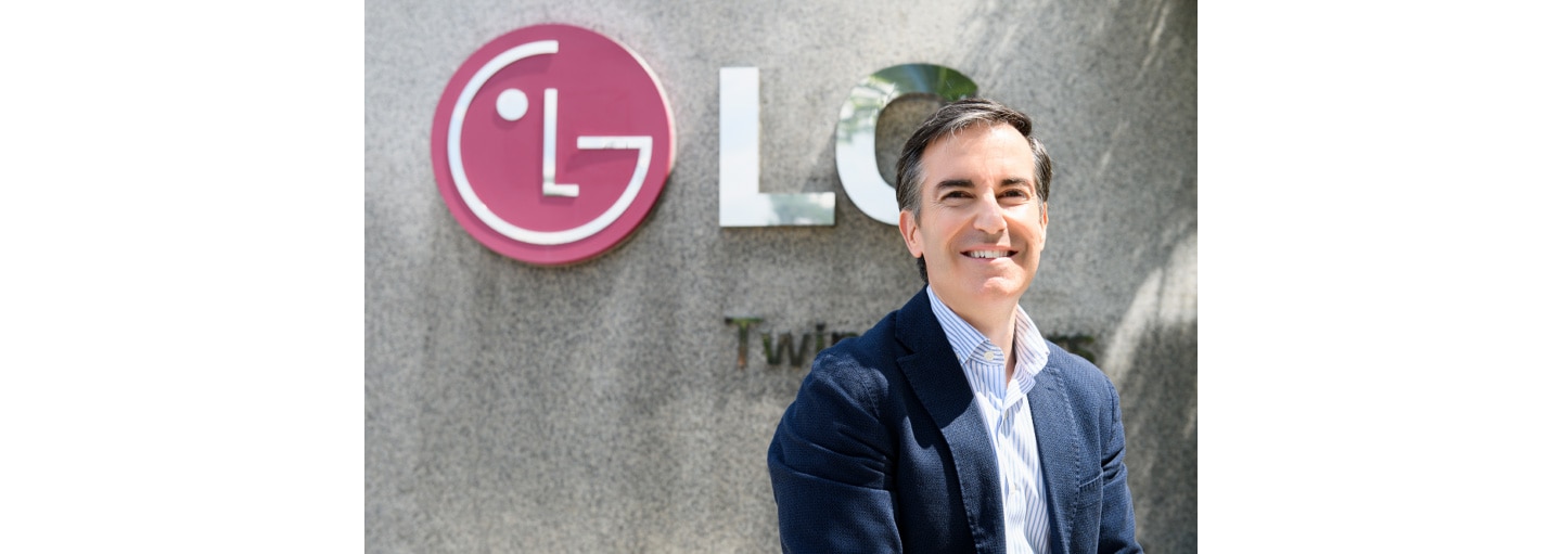 Carlos Olave, LG Global HR Leader, posing in front of the LG logo outside LG Twin Towers in Seoul. 