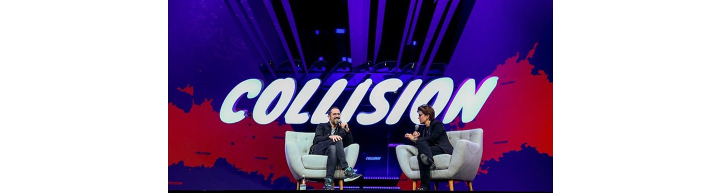 A photo of a host and a guest having a discussion at the Collision event