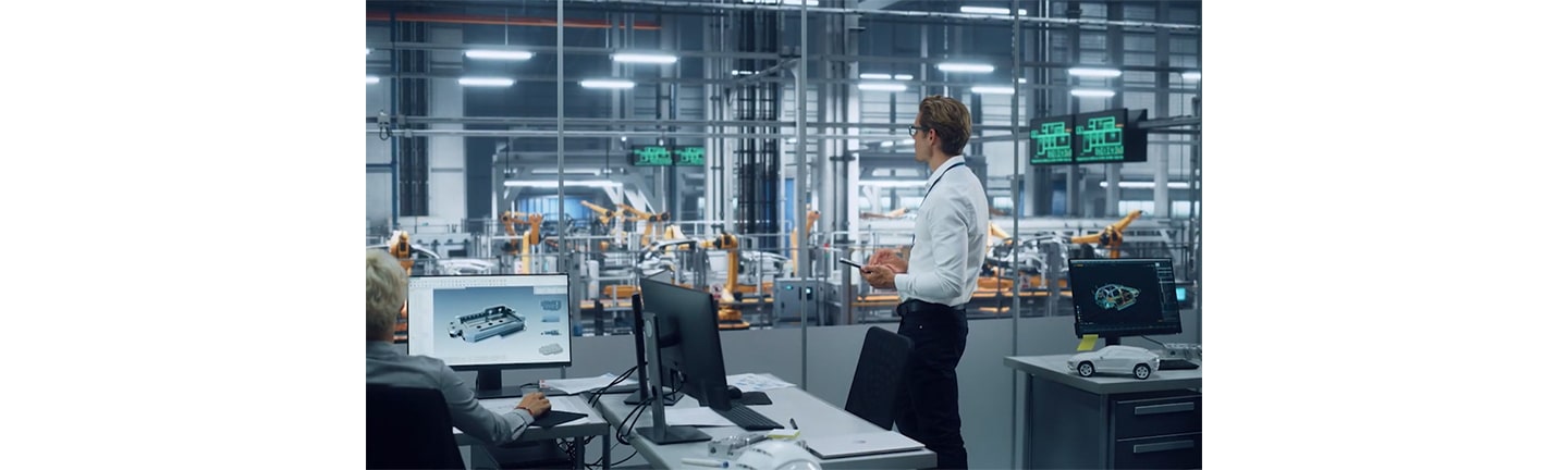 A worker looking over the production process of machines