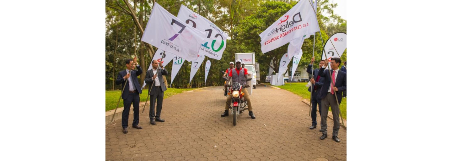 LG technicians riding in on motorcycles in front of LG trucks to celebrate The Last Mile program.