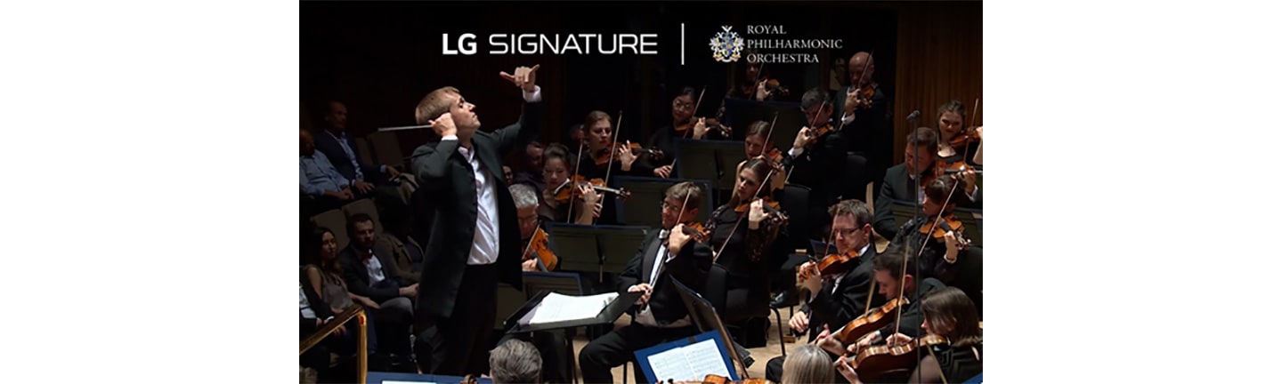 The conductor and violinists of the Royal Philharmonic Orchestra during a performance with the logos of LG SIGNATURE and the orchestra above