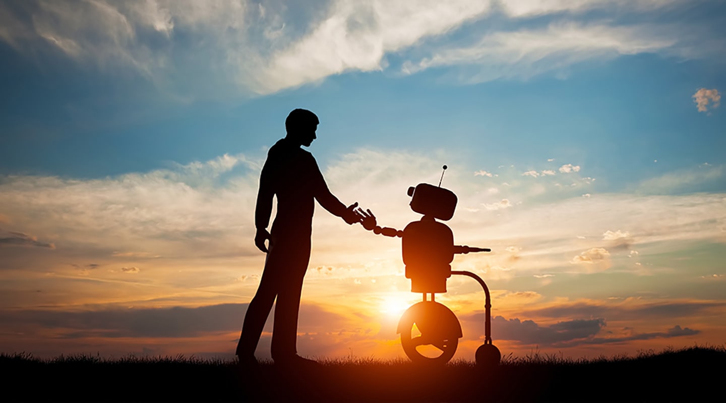  A human and a robot shaking hands during the sunset.