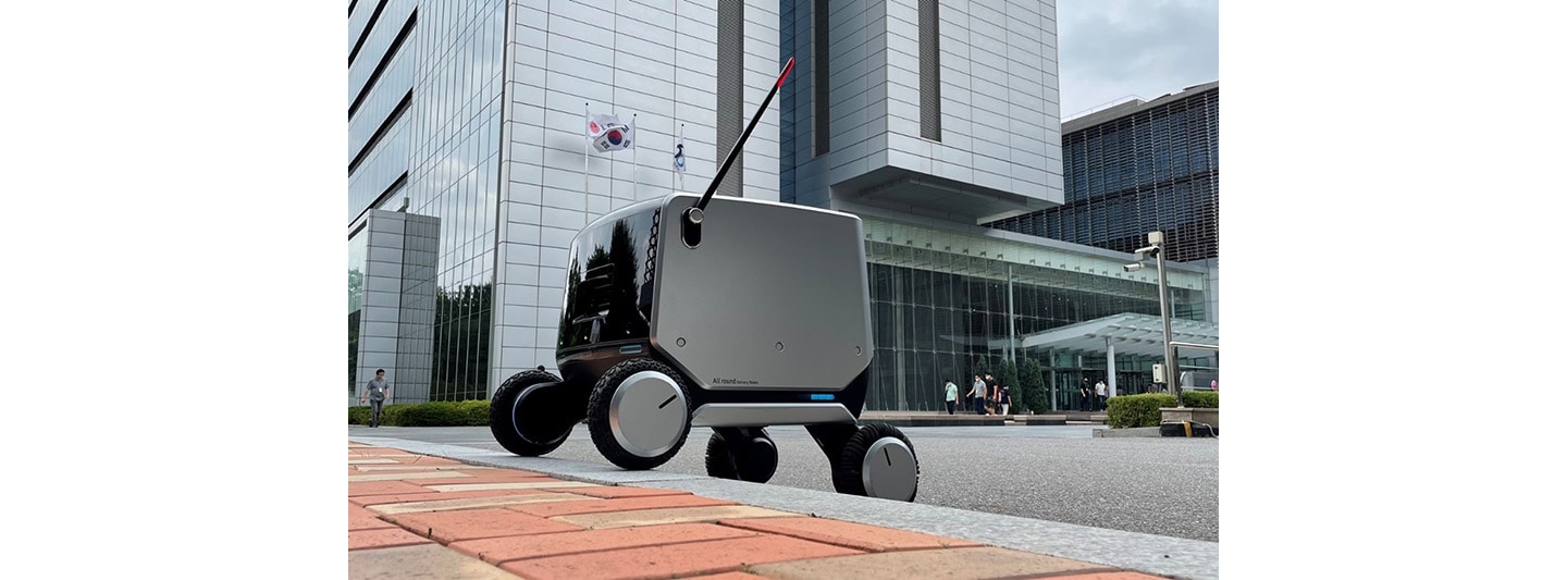 LG’s four-wheeled indoor-outdoor delivery robot moving up a bump without assistance.