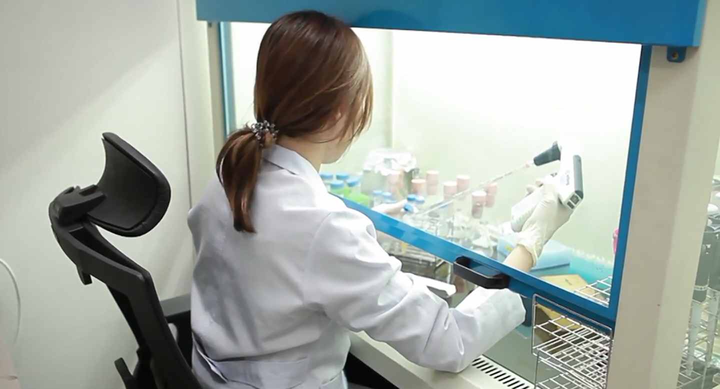 A researcher using specialized lab equipment to carry out tests. 