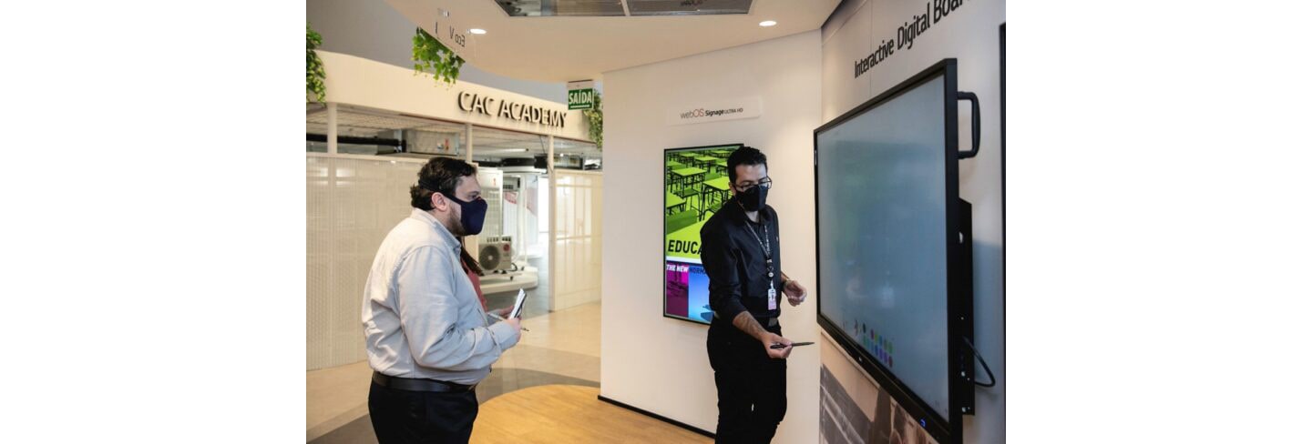 Two men experiencing the Interactive Digital Board installed at The LG Business Solution Center.