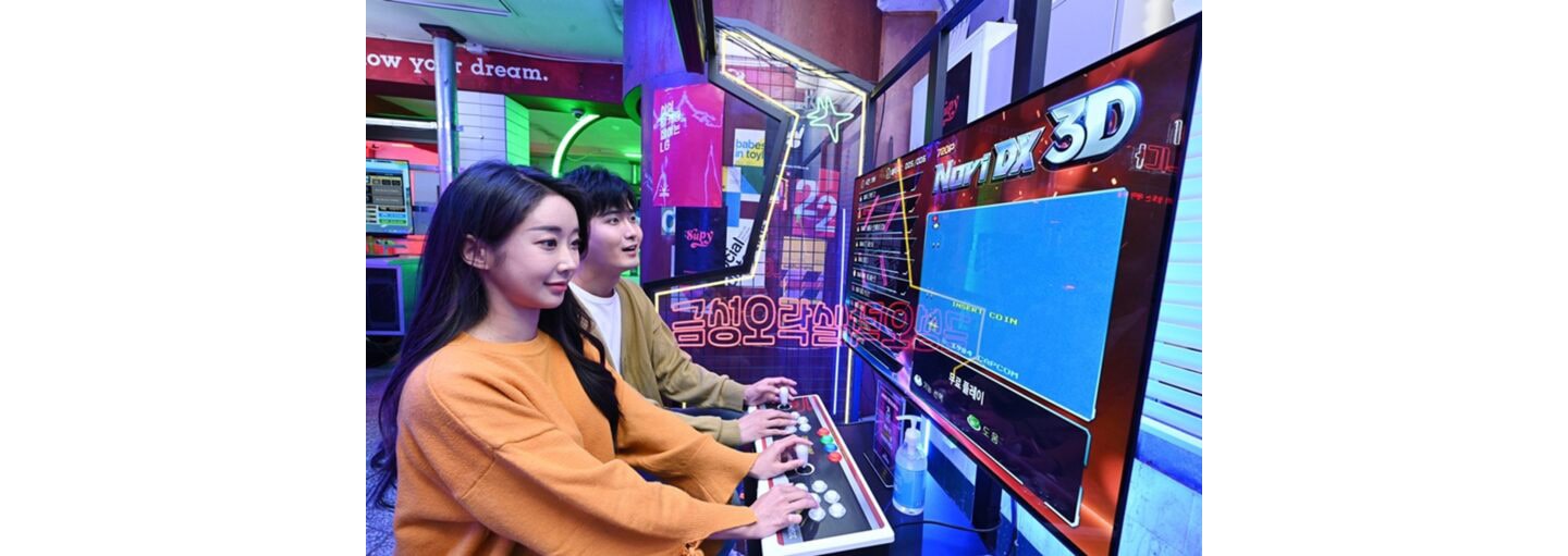 A couple playing an arcade game at Gold Star Arcade in Seoul.