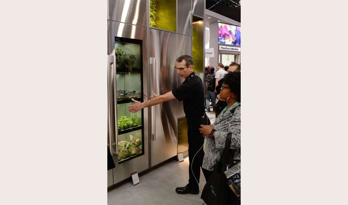 An LG employee demonstrating LG’s unique indoor gardening appliance to visitors at CES 2020