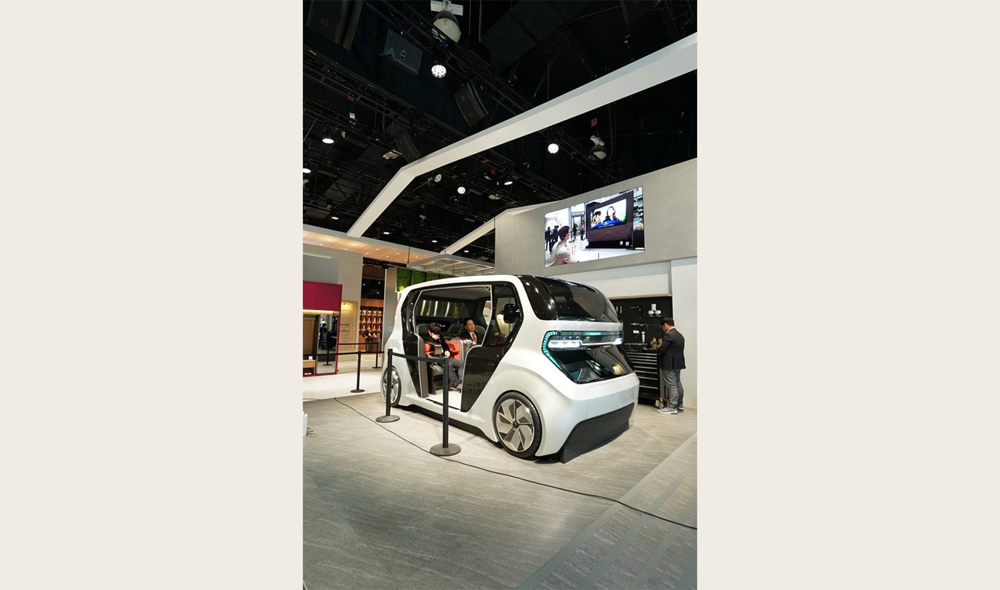 A front side view of LG’s Connected Car concept with two people sitting inside, which was unveiled at CES 2020 to highlight the future of cars via LG ThinQ