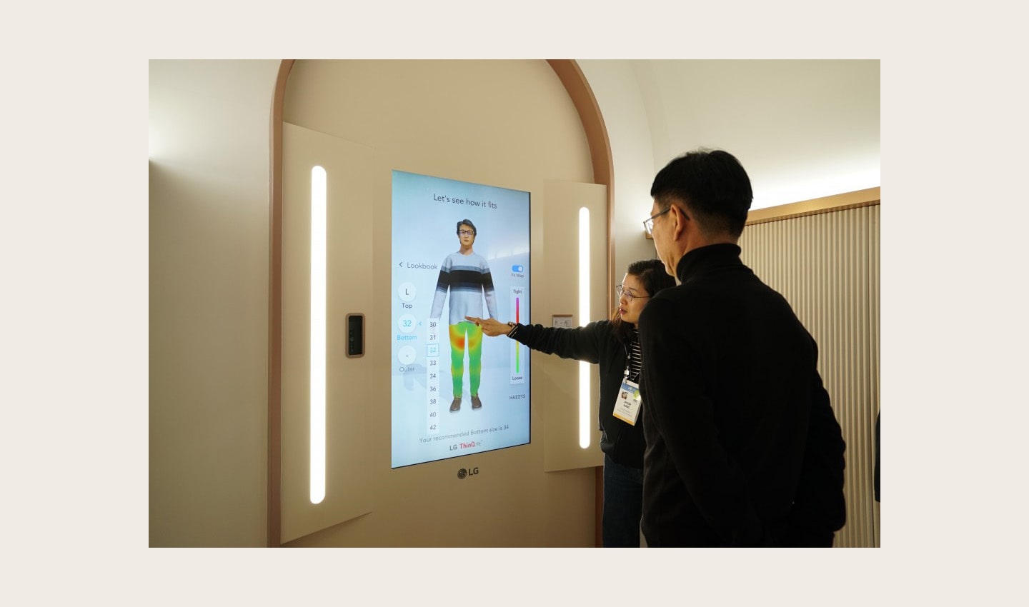 An LG representative takes a visitor through the Style Lab to see how well his clothes fit at the company’s CES 2020 LG ThinQ fit Collection booth