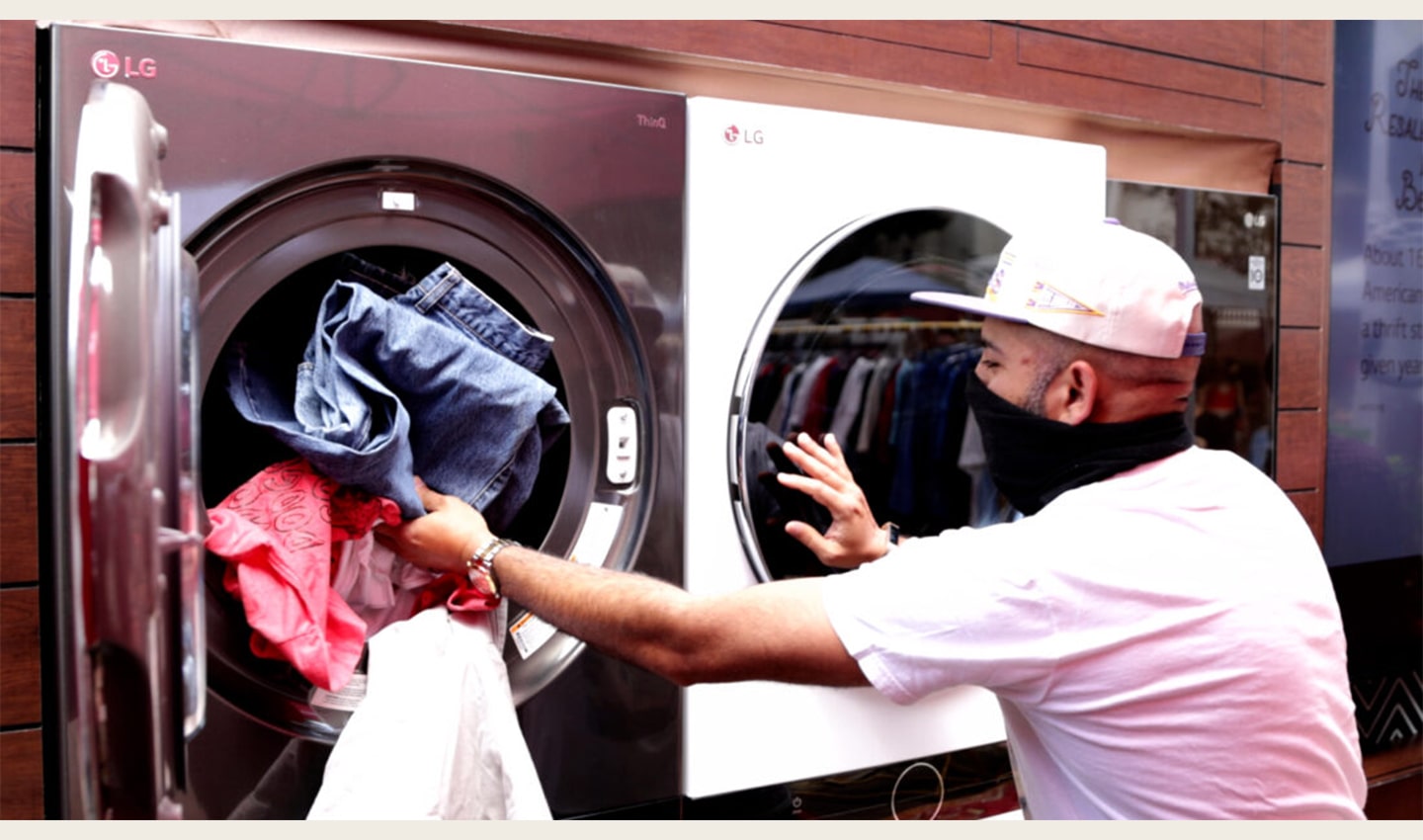 A man putting laundry into the LG washing machine so that they are fully sanitized and hygienic before being donated to local beneficiaries