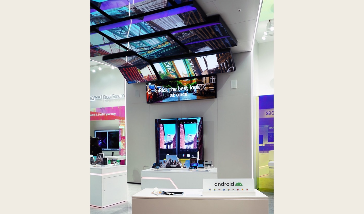 The LG G8X ThinQ zone is viewed from the other direction and the zone demonstrates the key features of LG G8X ThinQ using a number of large TV displays.