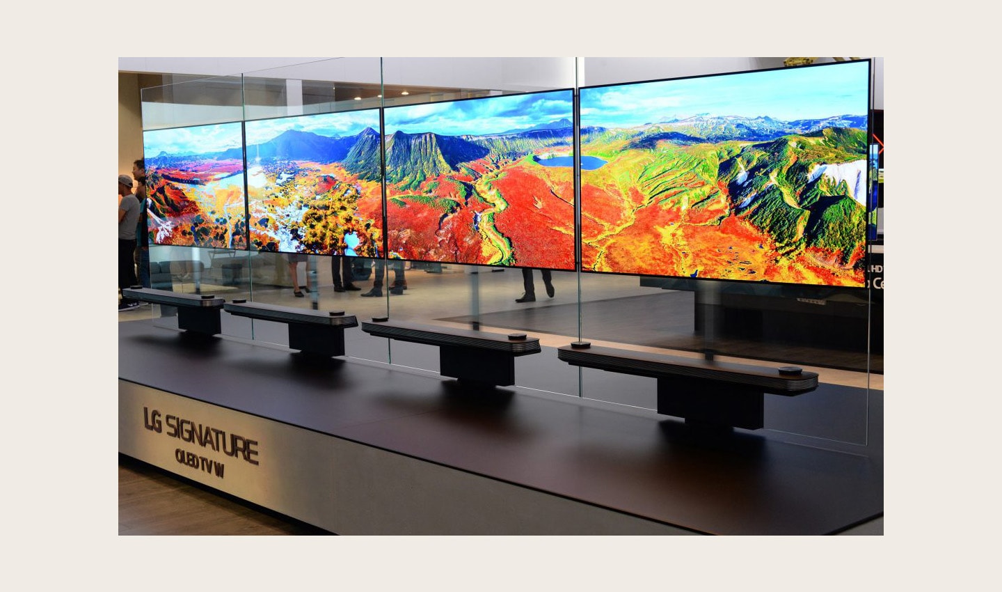 Another view of four LG SIGNATURE OLED TV W sets installed side by side on a display stand.