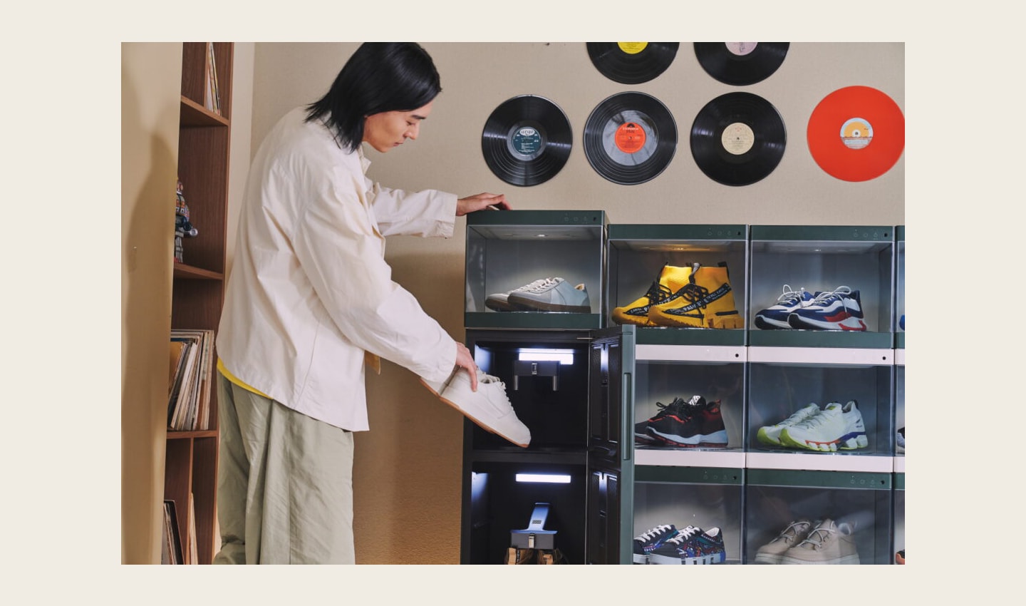 A man is putting a pair of his shoes in the LG Styler ShoeCare