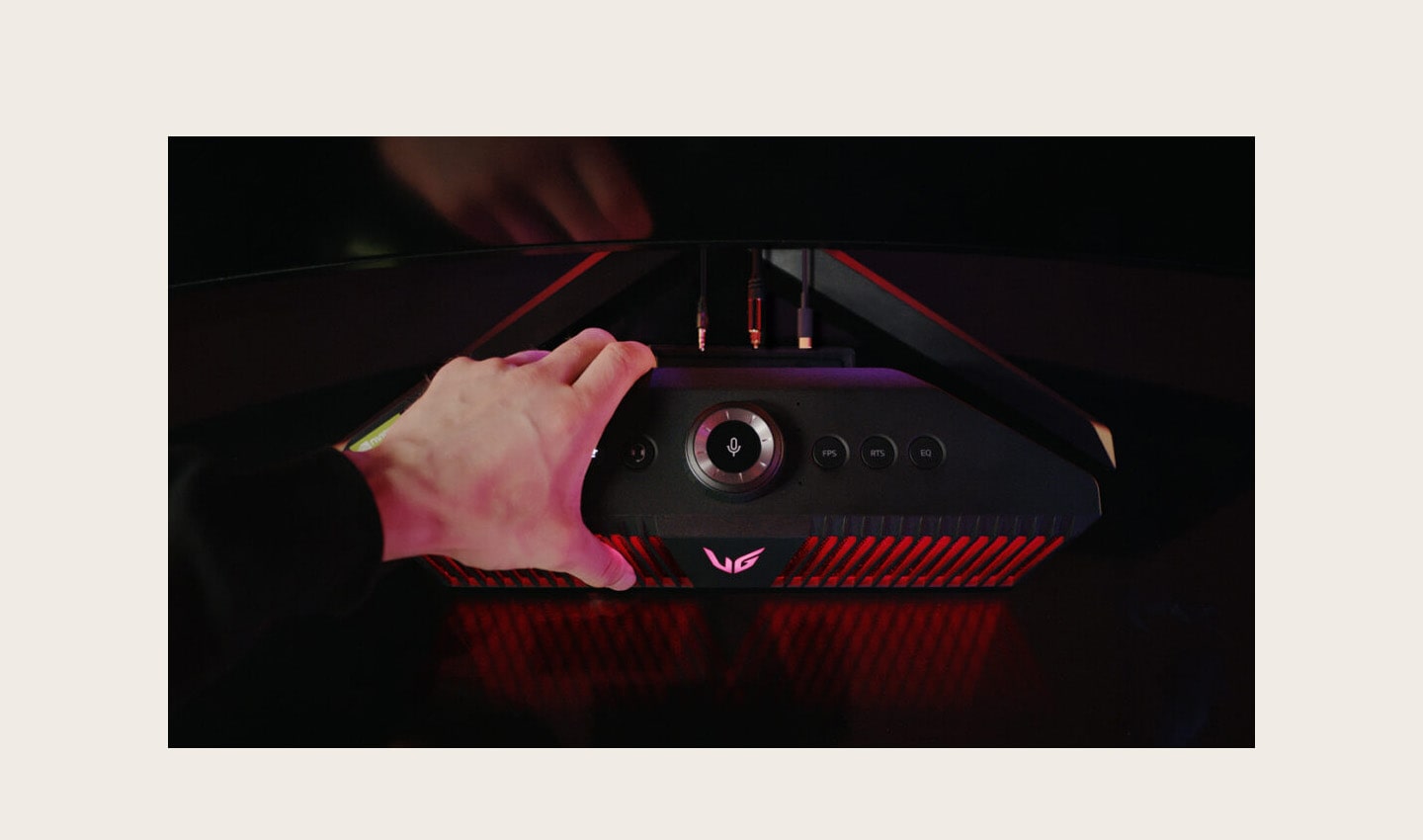 A gamer grasping an LG UltraGear Gaming Speaker (model GP9)