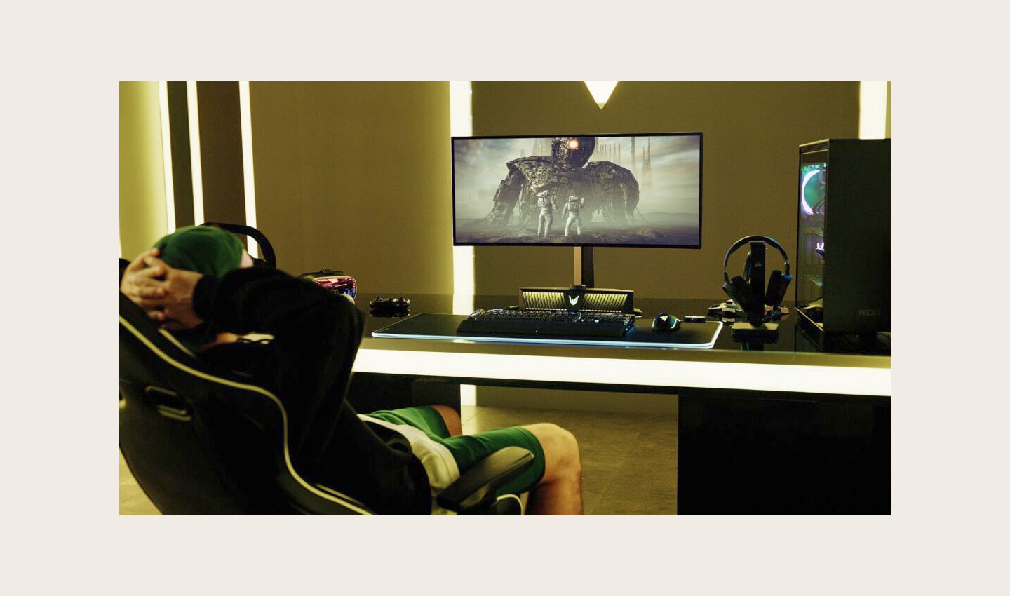 A gamer watching a game on an LG UltraGear gaming monitor connected to an LG UltraGear Gaming Speaker (model GP9)