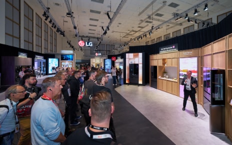 Attendees on the LG media booth tour watch a presenter demonstrate the Fit&Max refrigerators at the LG IFA 2026 exhibition.