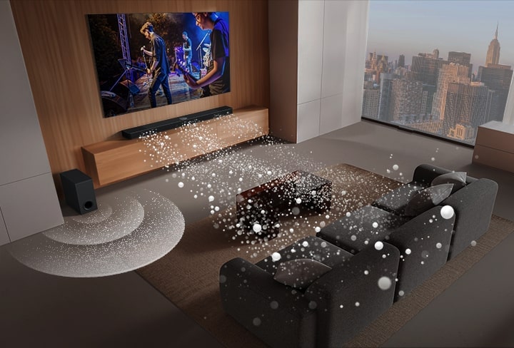 An image of an LG TV and LG Soundbar in a living room playing a musical performance. White soundwaves made up of droplets project from the soundbar, looping around the sofa and living space to depict surround sound. A city skyline is visible through the window.