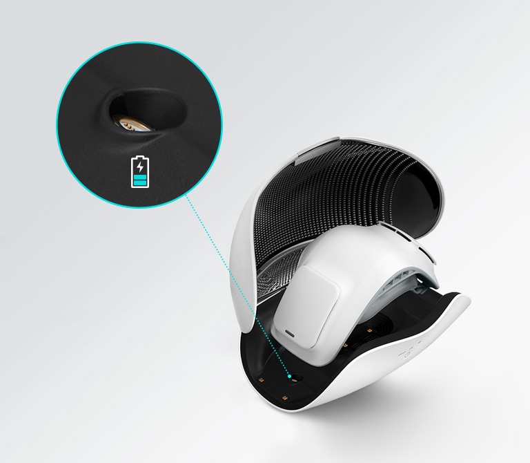 This image shows that there are charging terminals for the 1st generation wearable air purifier and the 2nd generation wearable air purifier in different locations, in the case of the 2nd generation wearable air purifier. A blue light on the side of the wearable air purifier inside and inset image in a circle with a line to the side of the mask shows a magnified view of the place to recharge the mask. There is also a battery icon that is blue and almost empty indicating it's time to plug it in.